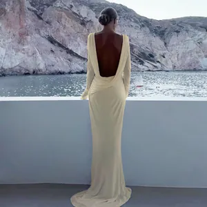 Elegant backless long-sleeved evening gown with a slim fit and floor-length silhouette.