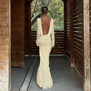 Elegant pale yellow long sleeve backless maxi dress with draped cowl back detail