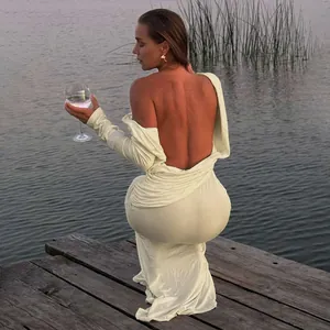 Back view detail of an elegant sexy backless long sleeve cream maxi dress for women.
