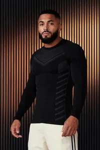 Detailed view of men's slim-fit black athletic long-sleeve shirt with patterned chest.