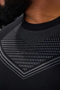 Close-up view of breathable V-shaped mesh texture on men's black athletic long sleeve tee