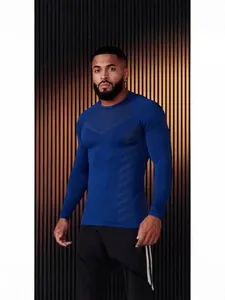 Detailed view of a men's blue slim-fit long-sleeve sports t-shirt worn by a model