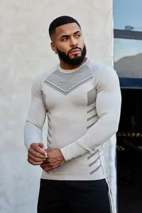 Detail showing slim fit long-sleeve sports shirt with geometric prints on model