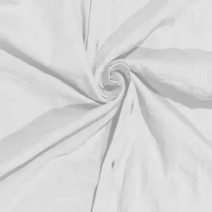 Detailed close-up showing the soft white cotton fabric texture and precise buttonholes