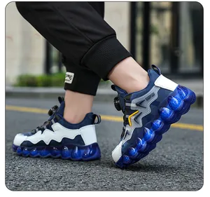 Side view of boys breathable sneakers with rotary buckle and blue translucent sole
