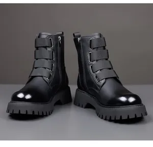 Front view of black leather Martin boots with decorative straps and side zipper