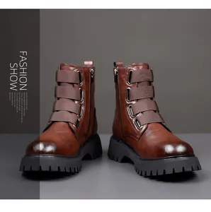 Close-up of brown leather Martin boots with decorative straps and metal buckles