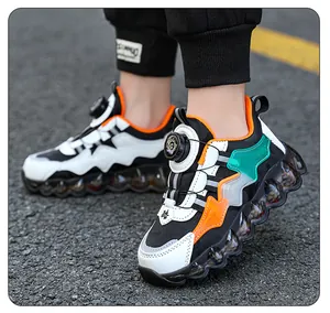 Children's breathable sports shoes with rotary buckle in black and white design.