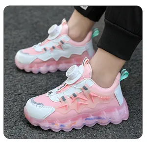 Detail of pink children's sneakers with rotary dial buckle and chunky soles