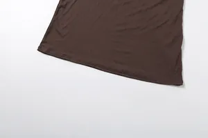 Detail view of the neat hem stitching on a brown slim-fit long-sleeved dress