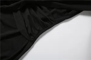 Close-up view showing the elegant pleated texture and soft fabric of the black slim dress