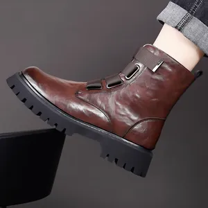 Close-up of brown leather motorcycle boot with thick lug sole and strap details