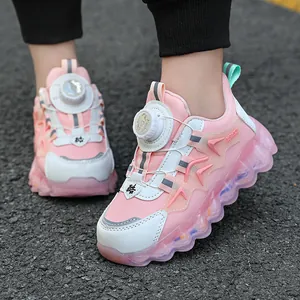Pink and white children's chunky dad sneakers with rotary buckle on asphalt road
