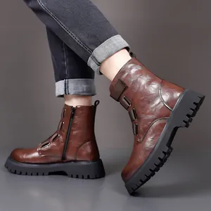 Close-up detail of stylish men's brown leather Martin boots featuring side zipper