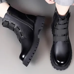 Close-up detail of black leather motorcycle boots with buckle straps and side zipper