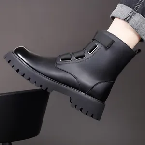Side profile of black leather Martin boots featuring a thick lug sole and buckle strap detail
