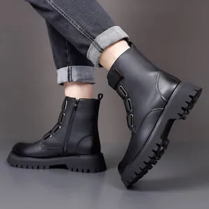 Detailed view of black leather British style boots with lug sole and side zipper
