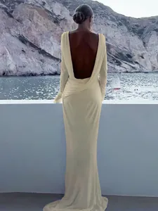 Elegant cream long sleeve backless maxi evening gown featuring a slim fit silhouette