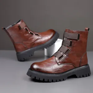 Close-up of brown leather Martin boots featuring tactical buckle straps and thick soles.