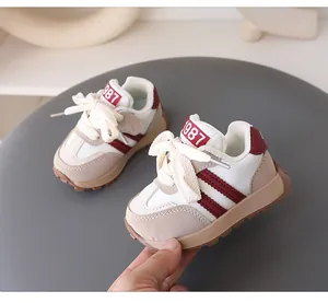 Detailed view of cream and burgundy toddler sneakers with retro 1987 design