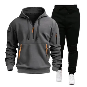 Detailed view of men's grey multi-pocket hoodie and black sports jogger set