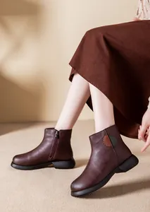 Side view of elegant brown leather ankle boots for women with side zipper and warm lining