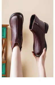 Detail of warm fleece lining and side zipper on dark brown winter ankle boots