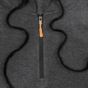 Close-up detail of dark grey sports hoodie with orange zipper puller and black drawstrings