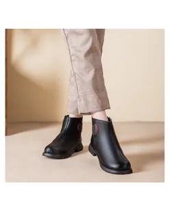 Detail of women's black warm fleece-lined short boots featuring side circular embroidery