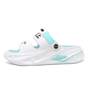 Side view of white men's thick-soled clog sandals with mint green accents and SMILE print.