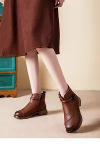 Brown leather ankle boots with warm plush lining and decorative flower buckle detail