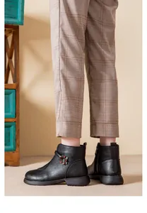 Close-up of black winter short boots with flower detail for elderly women