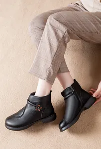 Cozy black leather ankle boots for middle-aged women featuring floral accents and side zipper
