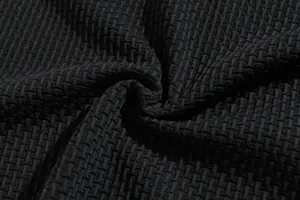 Close-up macro detail of premium black seersucker texture fabric for men's athletic shirts