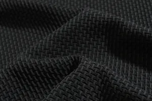 Close-up macro view of high-quality black puckered seersucker fabric texture for men's shirts