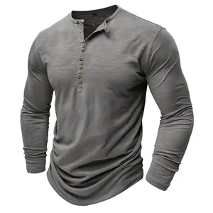 Detailed view of men's grey long sleeve Henley shirt with slub fabric texture and buttons