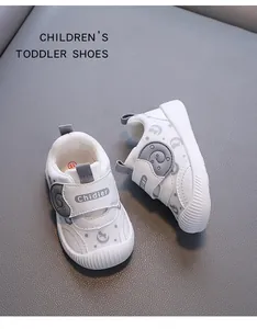 Close-up of breathable white toddler shoes with grey elephant strap and non-slip soles