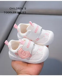 Close-up of white and pink breathable mesh toddler shoes with cute snail pattern
