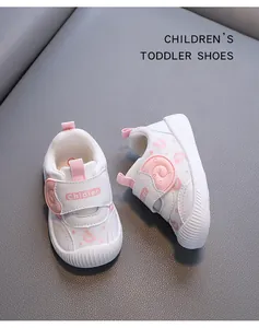 Detail view of breathable white toddler sneakers with pink accents and soft sole