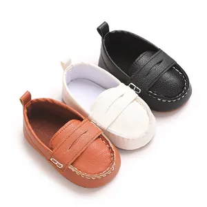 Detailed view of soft-sole baby leather loafers in tan, white, and black colors.