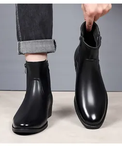 Macro detail view of classic black leather Martin boots with side zipper for men.