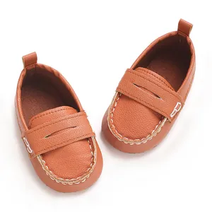 Close-up view of stylish brown soft-sole baby loafers featuring white contrast stitching details