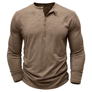 Close-up of a brown long-sleeved Henley shirt with slub texture and multiple buttons.