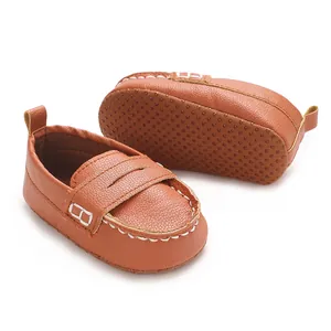 Detailed close-up of brown infant soft sole loafers showing non-slip dots and stitching