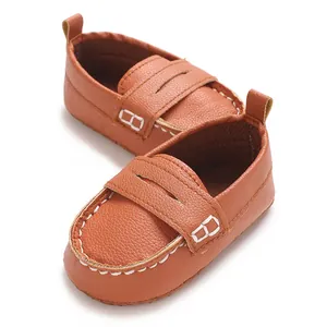 Close-up of brown infant soft sole leather loafers with white stitching details