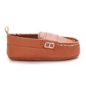 Side view of brown infant soft-sole leather loafers with anti-slip bottom detail