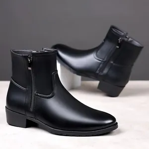 Close-up of black men's business leather ankle boots with side zipper detail.