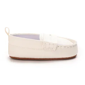 Side view of white soft-sole baby loafers with non-slip brown outsole.
