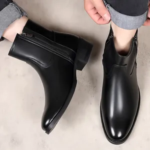 Detail view of men's black leather British style boots with side zipper