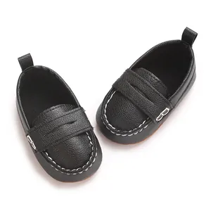 Close-up detail of black soft sole baby loafers featuring white contrast stitching